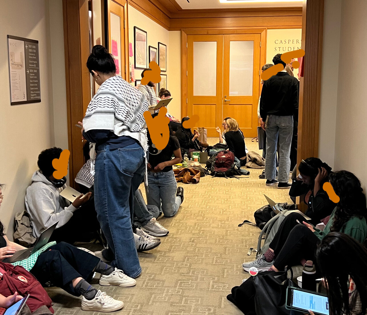 Students stationed outside HLS Dean of Students office. Faces covered to protect identity of attendees.