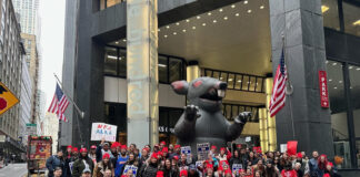 Mobilization for Justice (MFJ) workers picketting in front of the MFJ office in New York, NY. A large inflatable rat, a regular sight at picketting events, is displayed behhind the workers. (Miriam Shestack, 2024)