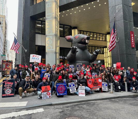Mobilization for Justice (MFJ) workers picketting in front of the MFJ office in New York, NY. A large inflatable rat, a regular sight at picketting events, is displayed behhind the workers. (Miriam Shestack, 2024)