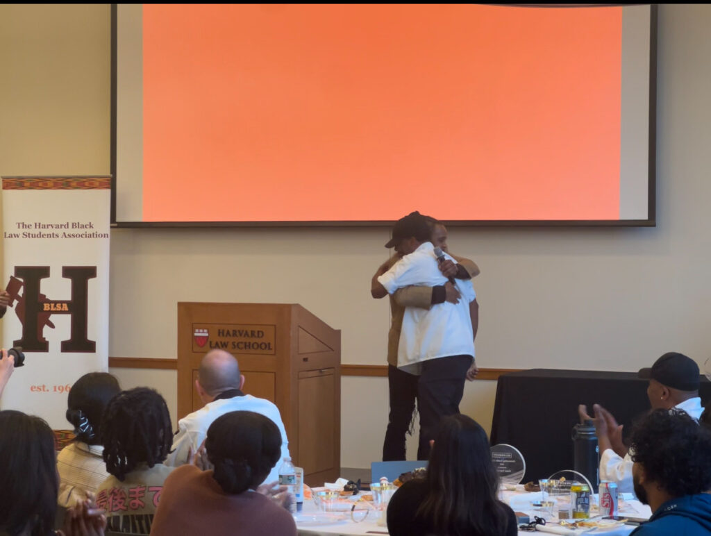Brione Merchant embraces Steven Folks after announcing his award win.